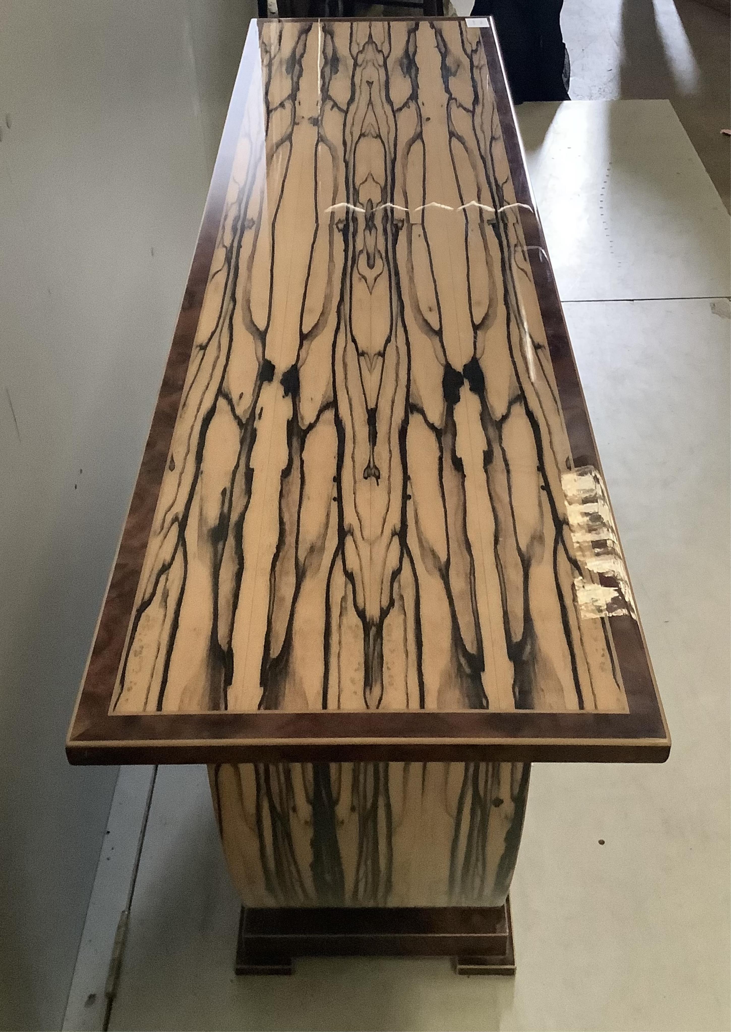 An Art Deco style white ebony and walnut console table